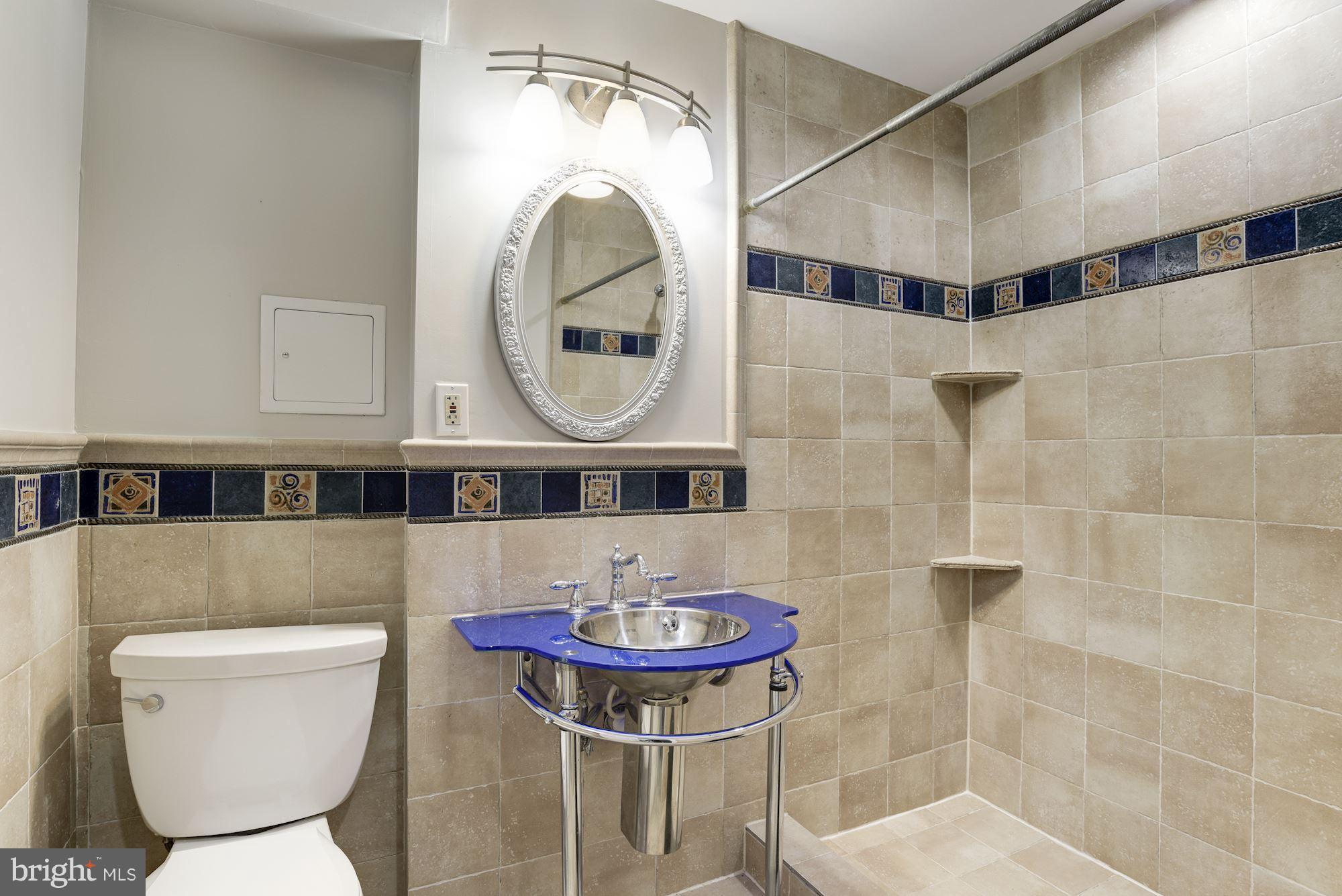 6916 Gilbert Street Springfield, VA 22150 - Photo 14 of 26 a bathroom with a toilet a sink and a mirror