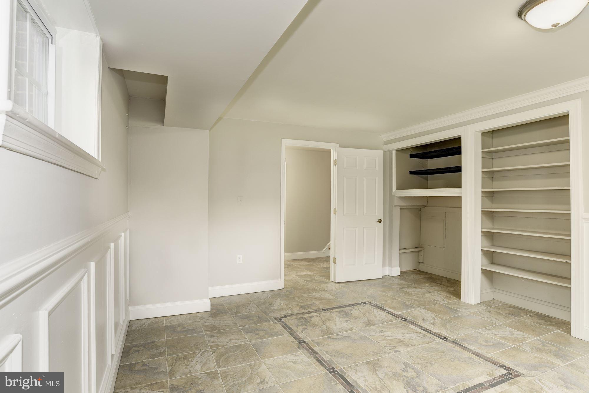6916 Gilbert Street Springfield, VA 22150 - Photo 20 of 26 a view of an empty room with a cabinet and a window