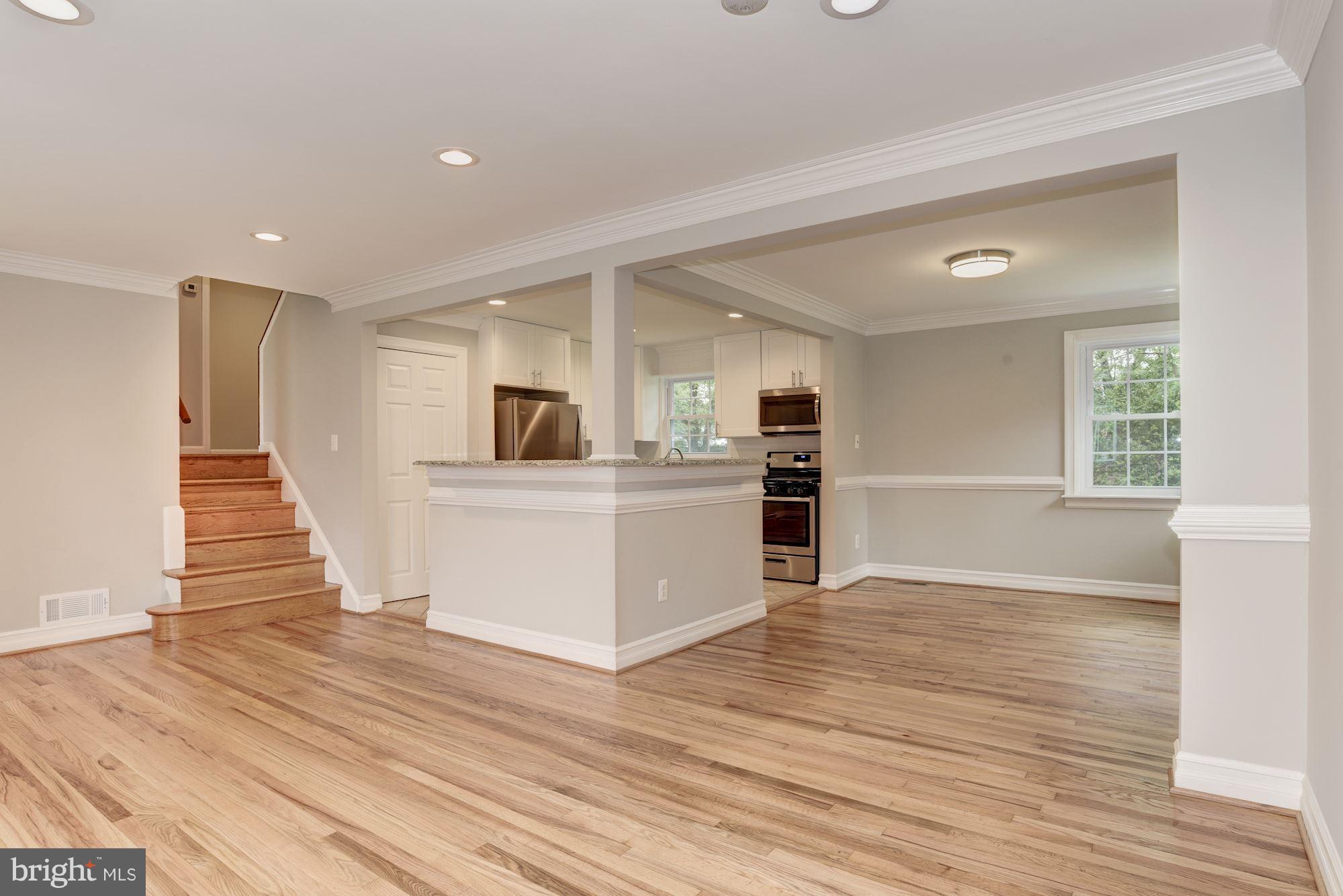 6916 Gilbert Street Springfield, VA 22150 - Photo 3 of 26 a view of a kitchen with wooden floor and electronic appliances