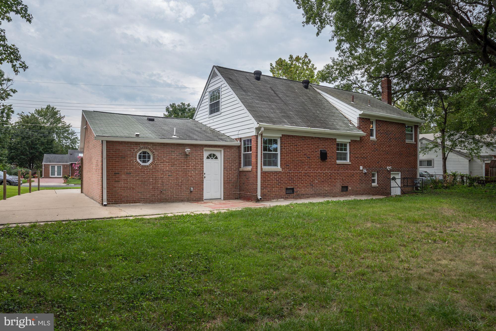 6916 Gilbert Street Springfield, VA 22150 - Photo 22 of 26 a front view of house with yard and green space