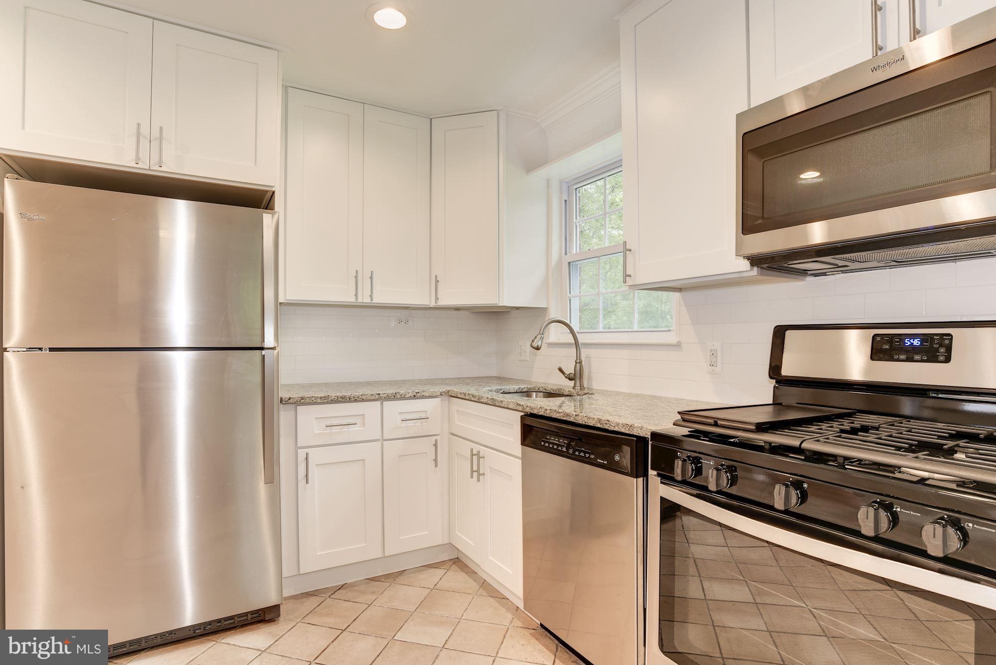 6916 Gilbert Street Springfield, VA 22150 - Photo 6 of 26 a kitchen with stainless steel appliances granite countertop a refrigerator and a stove