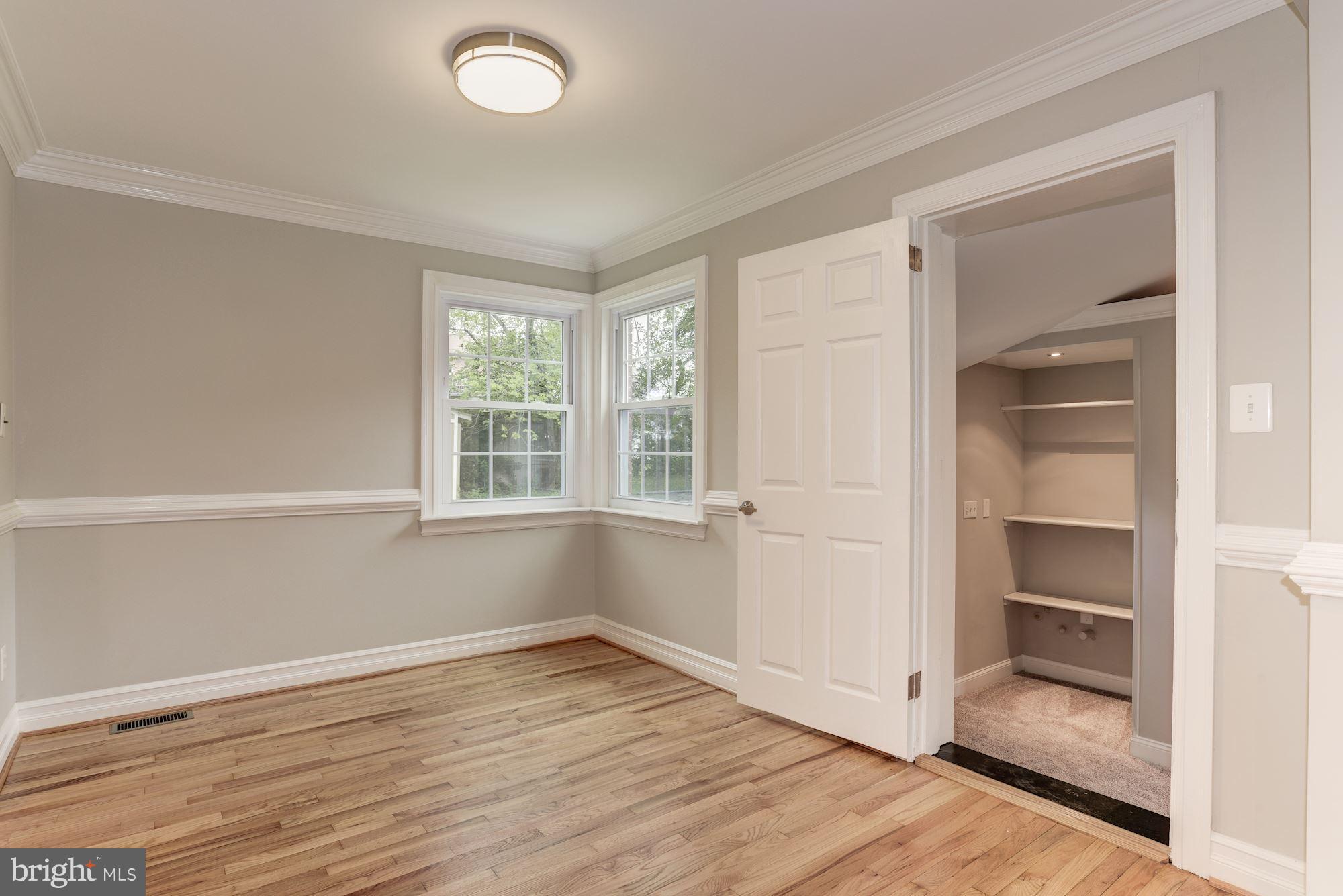 6916 Gilbert Street Springfield, VA 22150 - Photo 8 of 26 an empty room with wooden floor closet and windows