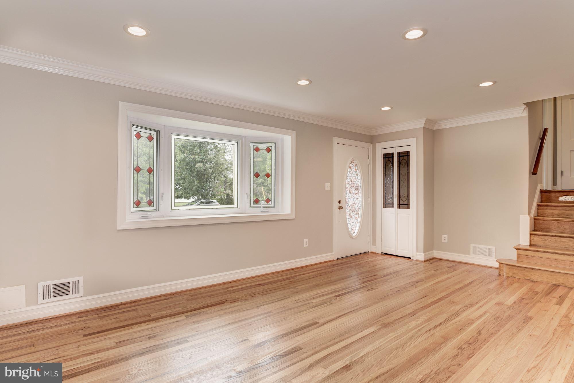 6916 Gilbert Street Springfield, VA 22150 - Photo 9 of 26 a view of an empty room with wooden floor and a window