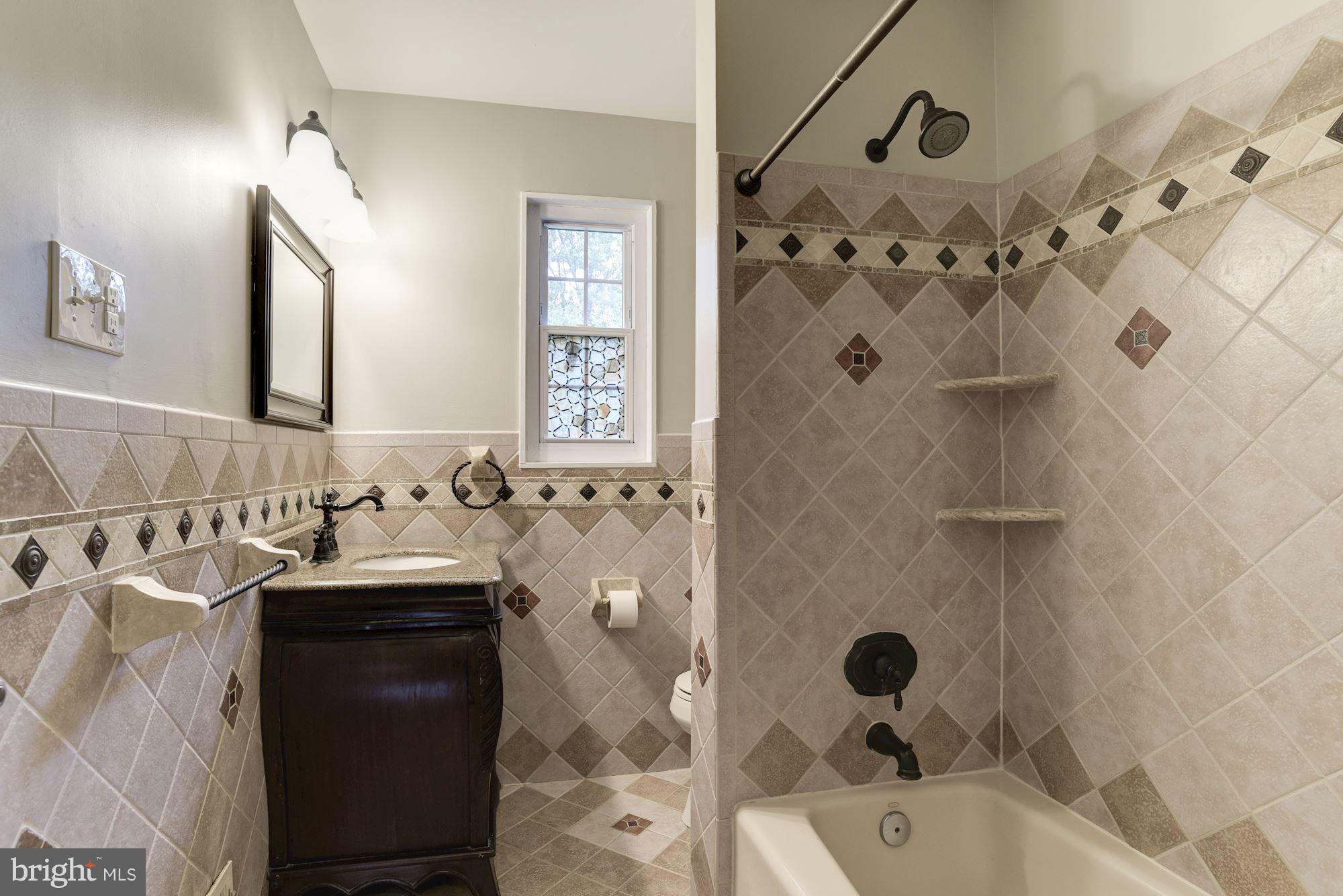 6916 Gilbert Street Springfield, VA 22150 - Photo 10 of 26 a bathroom with a bathtub and a sink
