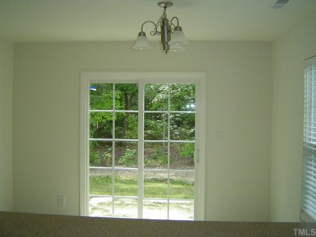 1504 Ricochet Drive Raleigh, NC 27610 - Photo 4 of 8 a view of a room that has a window in it