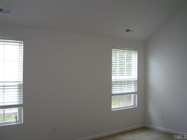 1504 Ricochet Drive Raleigh, NC 27610 - Photo 5 of 8 an empty room with a window