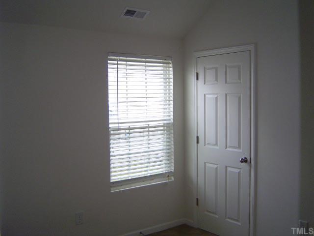 1504 Ricochet Drive Raleigh, NC 27610 - Photo 6 of 8 a view of an empty room with a window