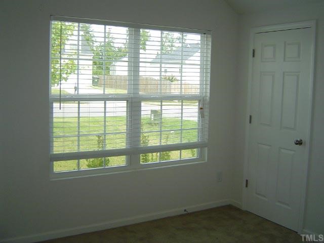 1504 Ricochet Drive Raleigh, NC 27610 - Photo 7 of 8 a view of an empty room with a window