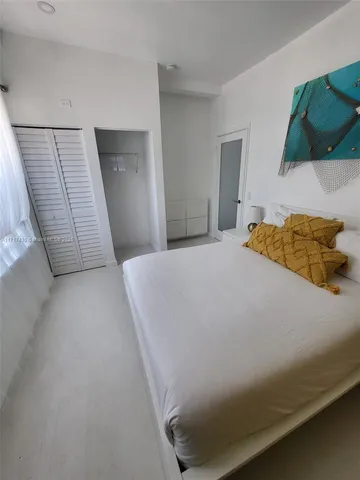 a bedroom with a bed and a mirror