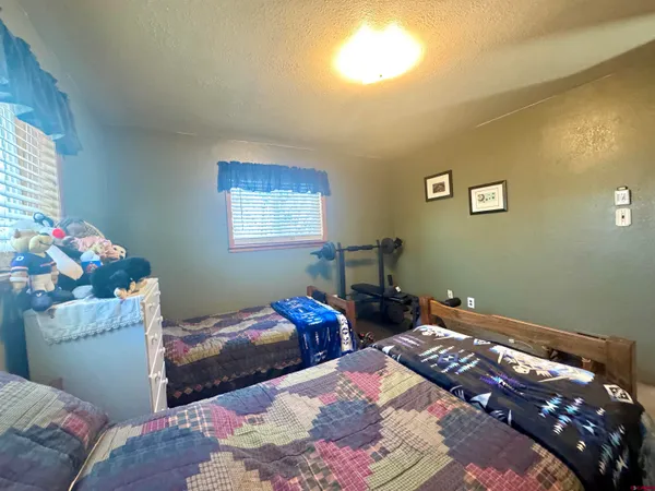 a bed sitting in a bedroom next to a window