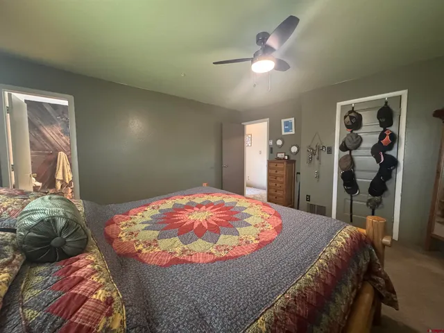 a bedroom with a bed and a mirror