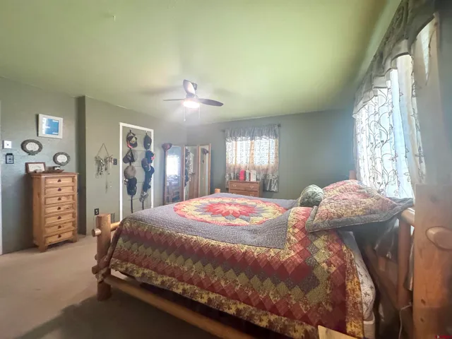 a spacious bedroom with a bed and a chandelier