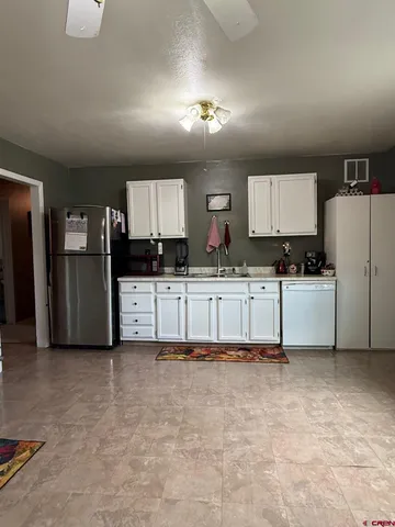 a kitchen with stainless steel appliances a refrigerator sink and cabinets
