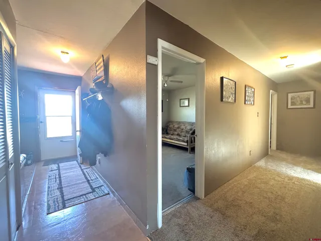 a view of a room with wooden floor and a bathroom