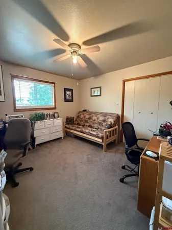 a bedroom with furniture and a window