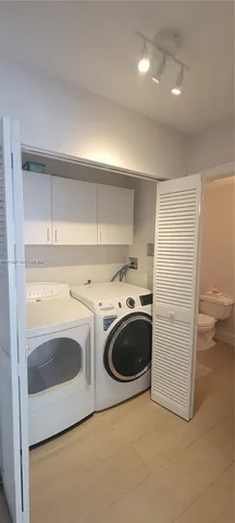 a utility room with sink washer and dryer