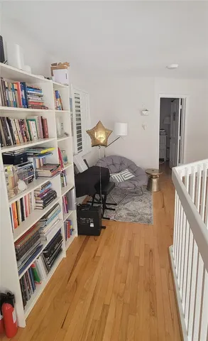 a bedroom with furniture and a book shelf