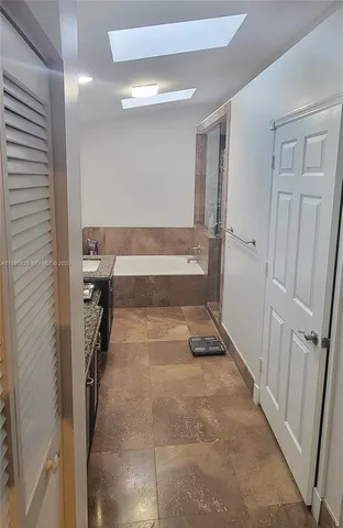 a bathroom with a tub and shower
