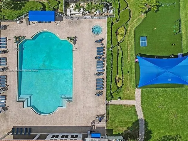 a view of swimming pool with outdoor seating and yard in back