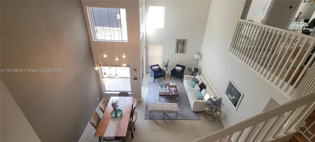 a view of a livingroom with furniture and stairs