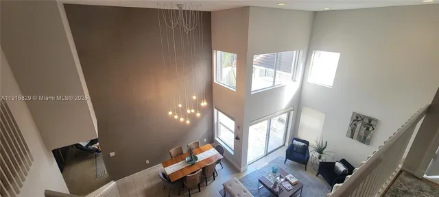 a living room with furniture and a mirror