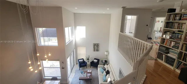 a view of a livingroom with furniture and staircase