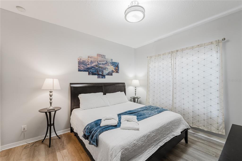 8961 Majesty Palm Road Kissimmee, FL 34747 - Photo 4 of 40 a bedroom with a bed and a painting on the wall