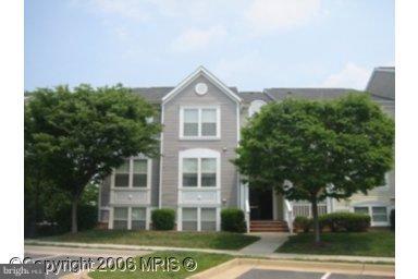 20600 Cornstalk Terrace, Unit 202 Ashburn, VA 20147 - Photo 1 of 12 a view of a house with a yard