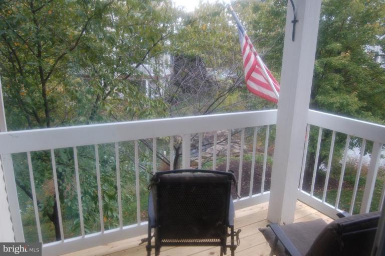 20600 Cornstalk Terrace, Unit 202 Ashburn, VA 20147 - Photo 2 of 12 a view of a chair and table in the balcony