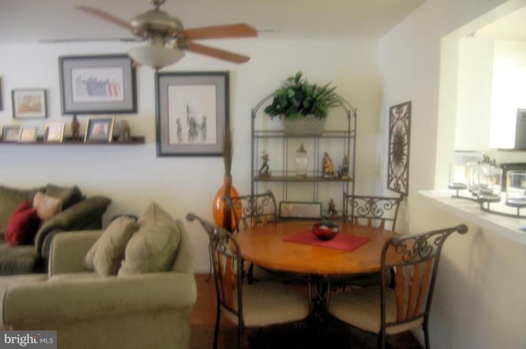 20600 Cornstalk Terrace, Unit 202 Ashburn, VA 20147 - Photo 8 of 12 a living room with furniture and a table