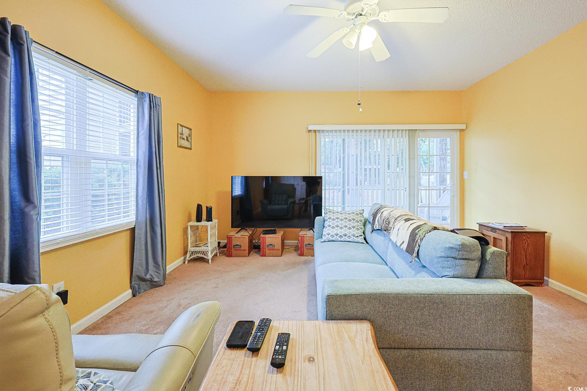 2302 Sweetwater Boulevard, Unit 2302 Murrells Inlet, SC 29576 - Photo 5 of 24 Living room featuring carpet flooring and a ceiling fan