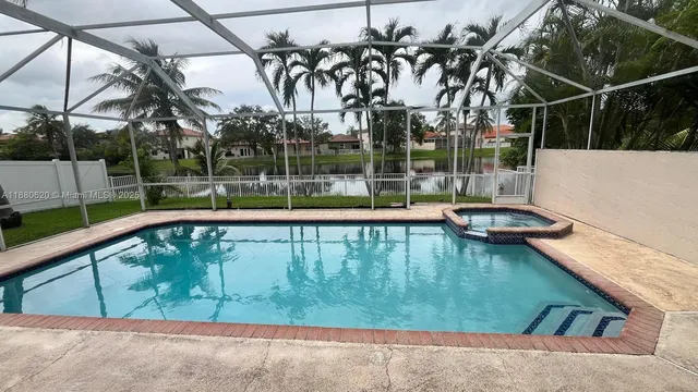 a view of swimming pool with a patio and a yard