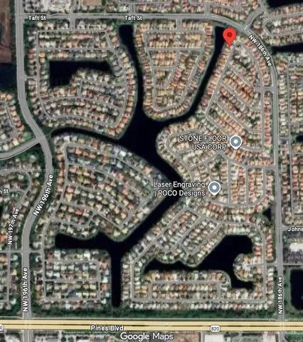 a palm tree sitting in front of a house with potted plants