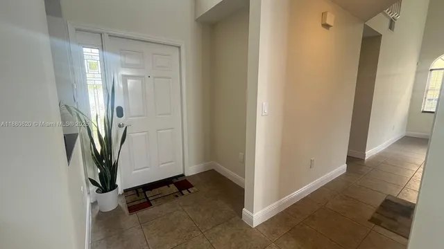 a view of a hallway view with wooden floor and staircase