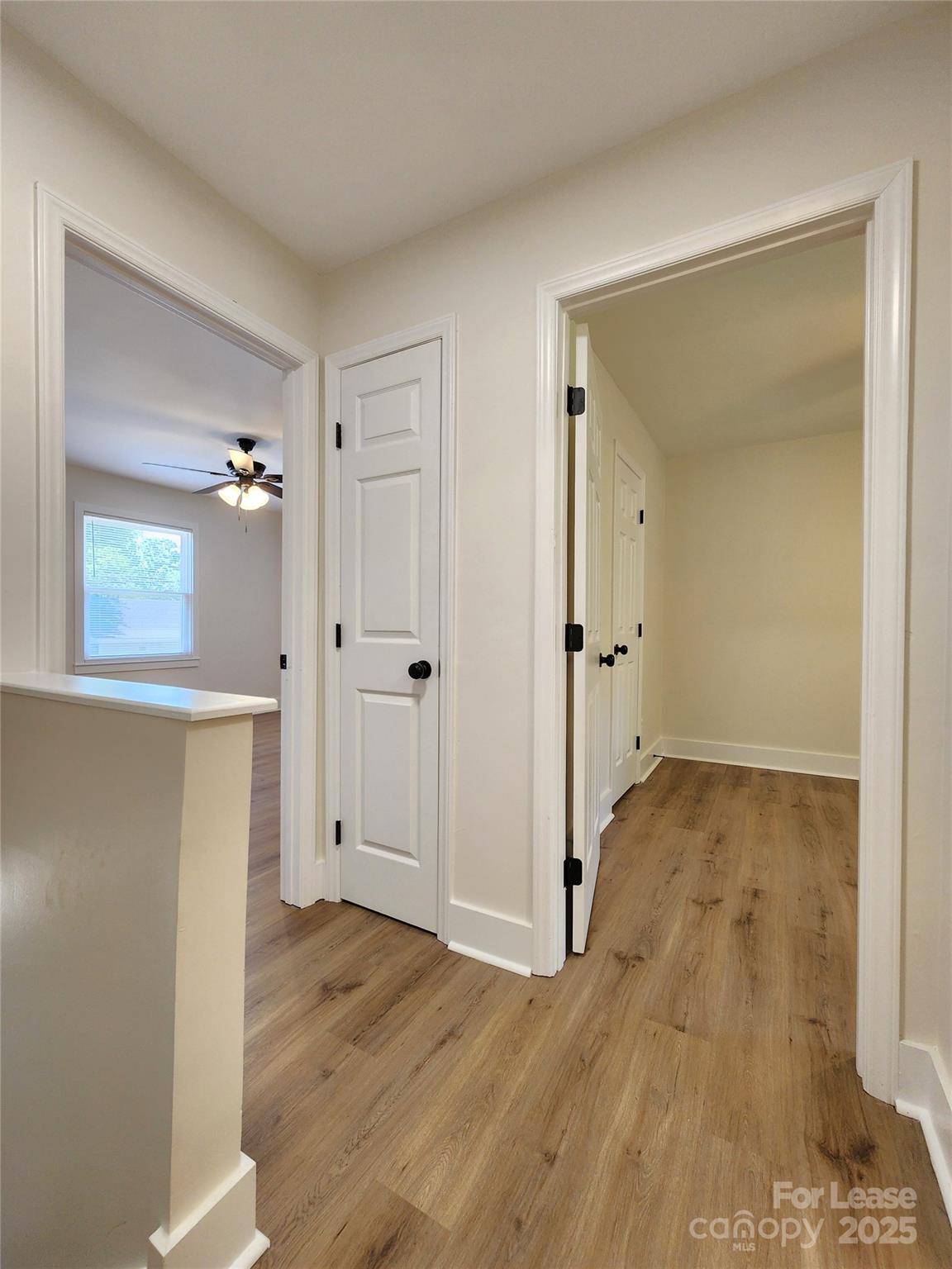 315 Hamilton Drive Northeast, Unit 5 Concord, NC 28025 - Photo 13 of 24 wooden floor with white walls