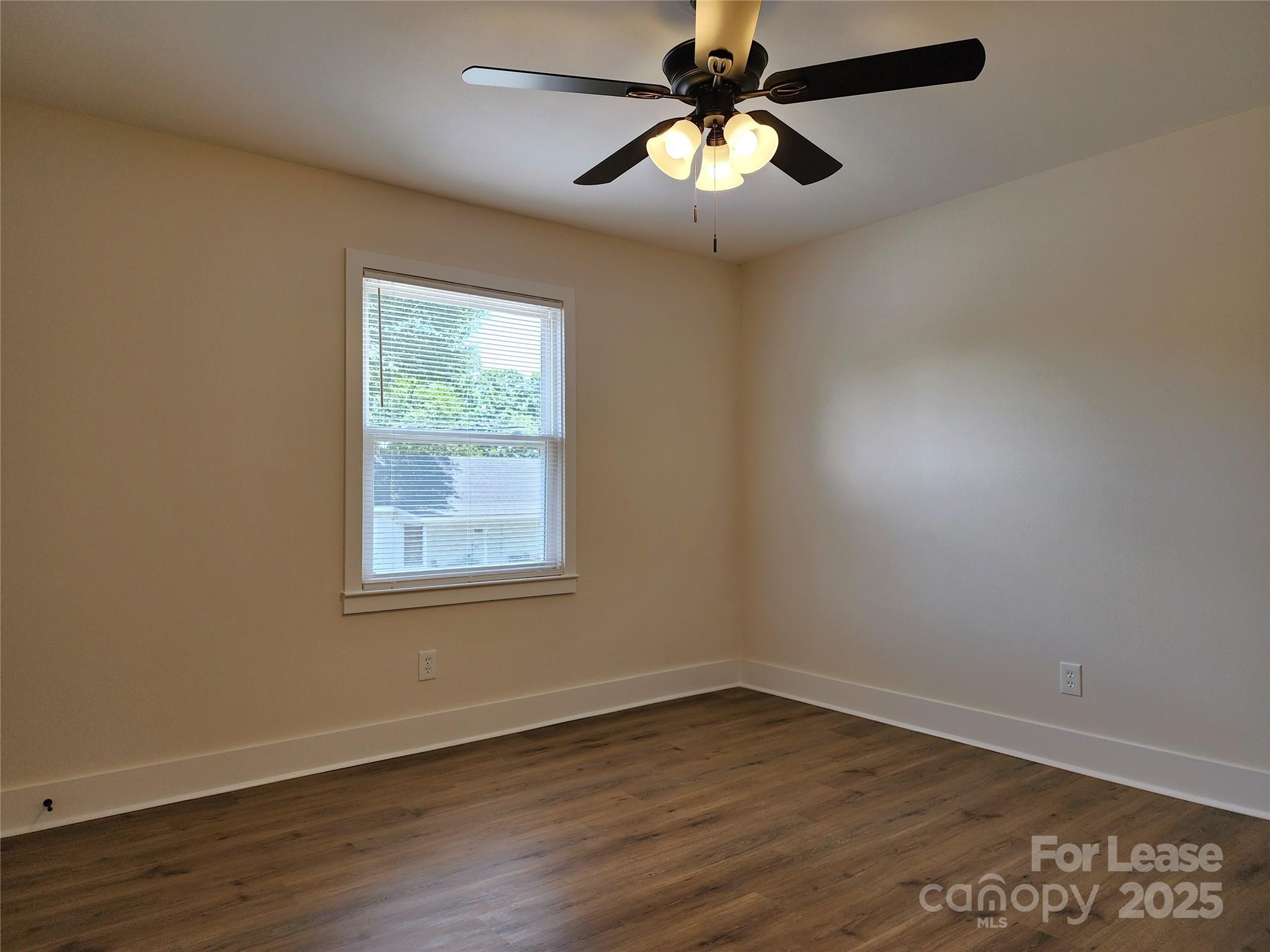 315 Hamilton Drive Northeast, Unit 5 Concord, NC 28025 - Photo 14 of 24 an empty room with wooden floor fan and windows