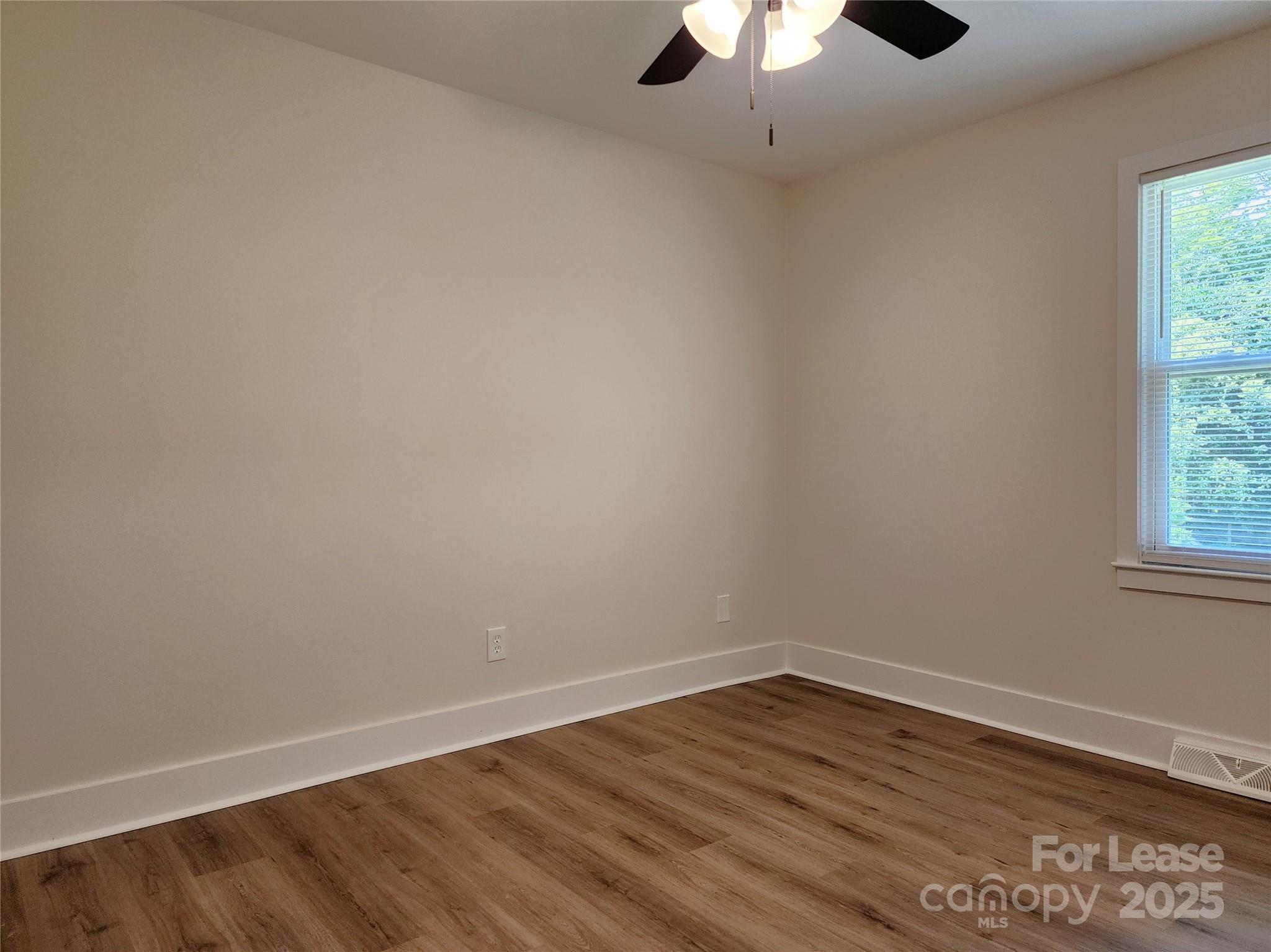 315 Hamilton Drive Northeast, Unit 5 Concord, NC 28025 - Photo 19 of 24 wooden floor in an empty room with a window