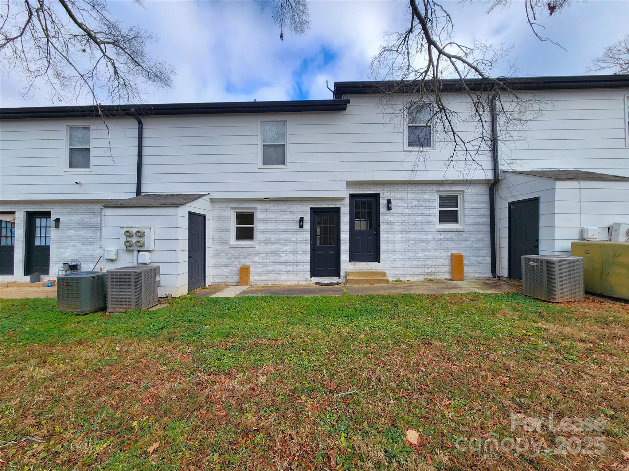 315 Hamilton Drive Northeast, Unit 5 Concord, NC 28025 - Photo 21 of 24 a view of a house with a yard and a large tree