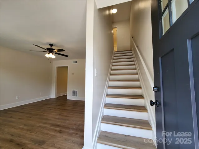a view of an entryway with wooden floor