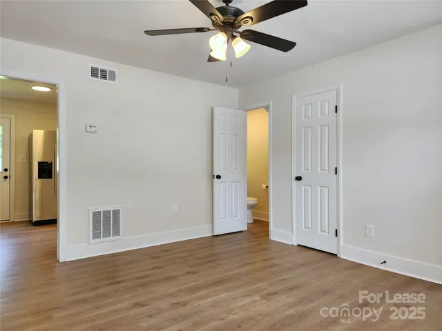 a view of an empty room and wooden floor