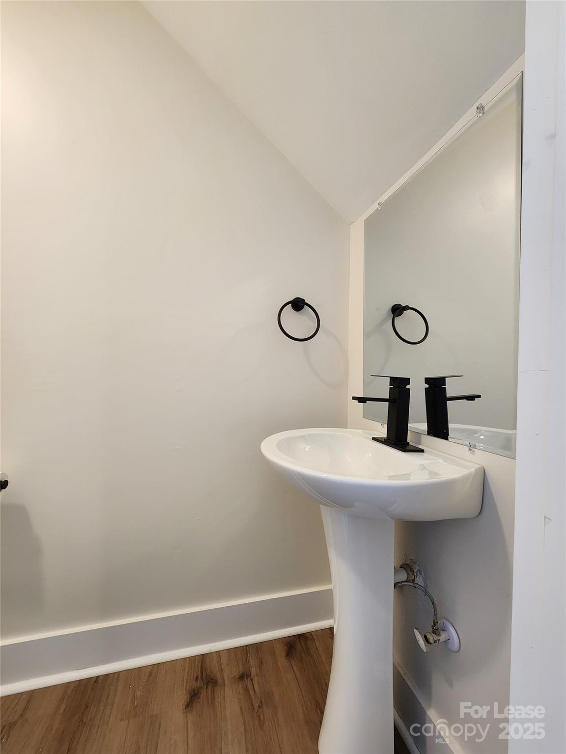 315 Hamilton Drive Northeast, Unit 5 Concord, NC 28025 - Photo 10 of 24 a bathroom with a sink a toilet and mirror