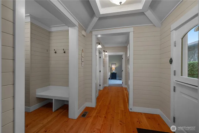 a view of a room with wooden floor and a bathroom