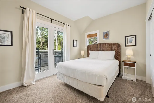 a bedroom with a bed and a large window