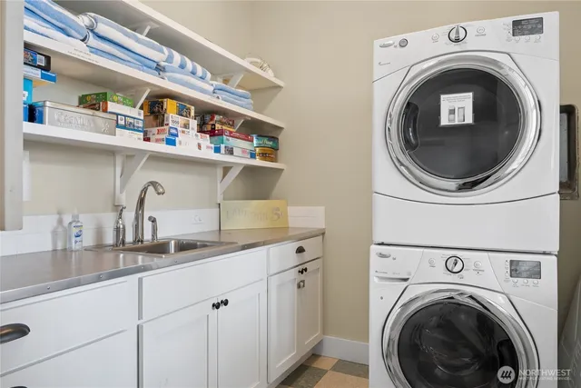 a utility room with sink dryer and washer