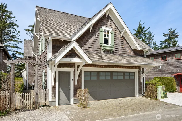 a view of a house with a garage and balcony