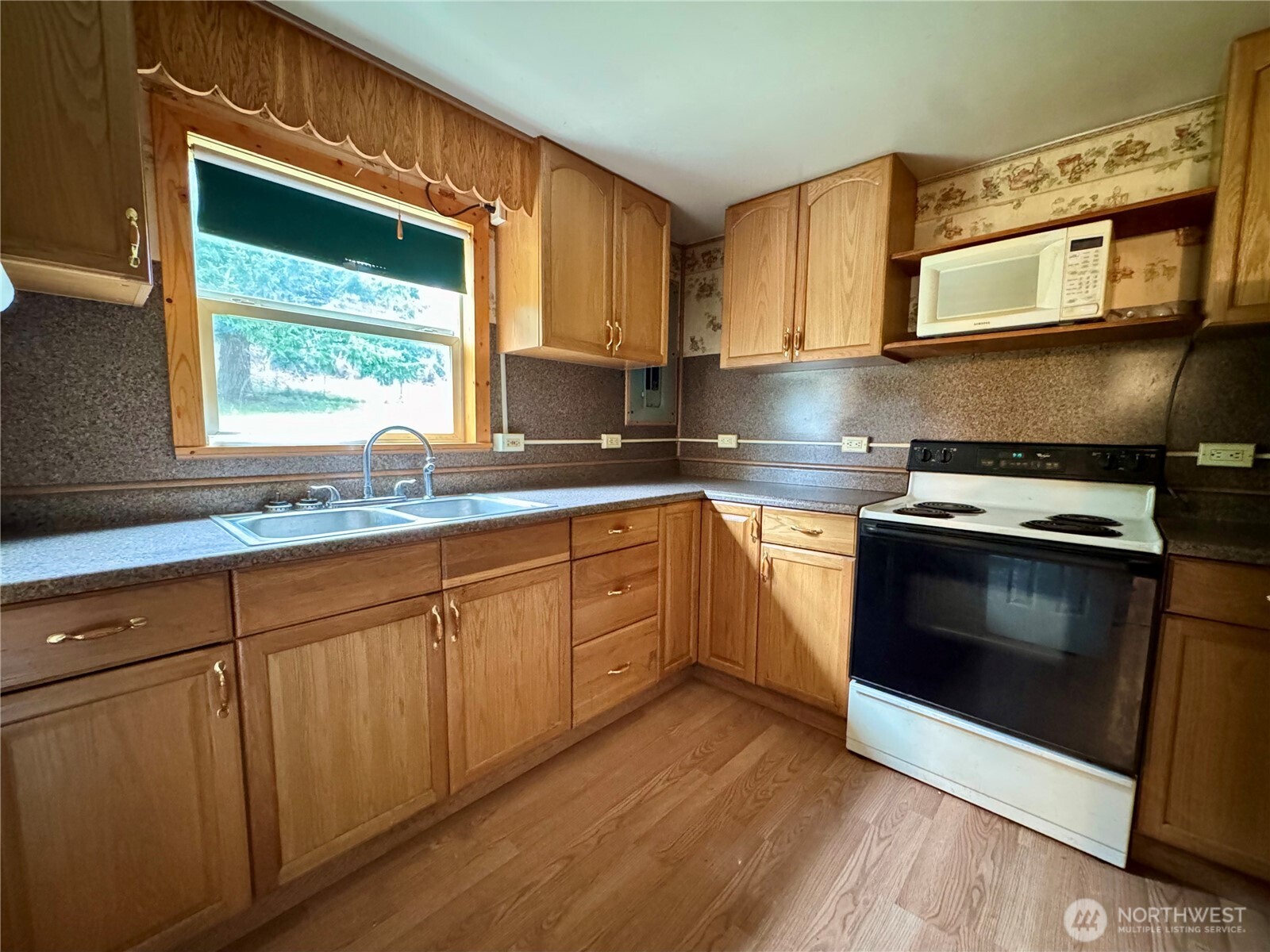 187 Wildcat Road Toutle, WA 98649 - Photo 6 of 21 a kitchen with stainless steel appliances granite countertop a stove a sink and a microwave