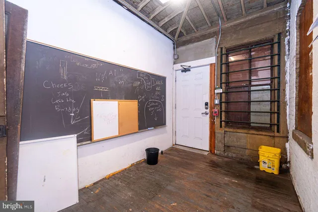 a view of a hallway with wooden shelves