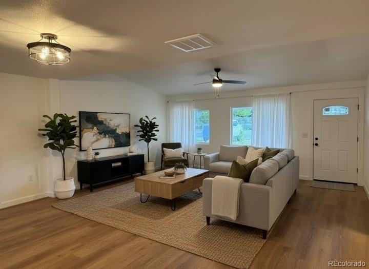 a living room with furniture and a lamp