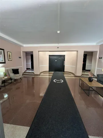 a gym room with table chairs and flat screen tv