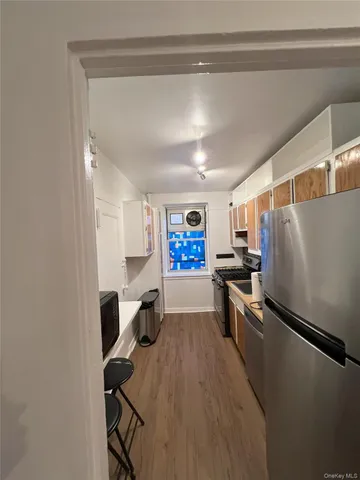 a kitchen with stainless steel appliances a refrigerator and microwave